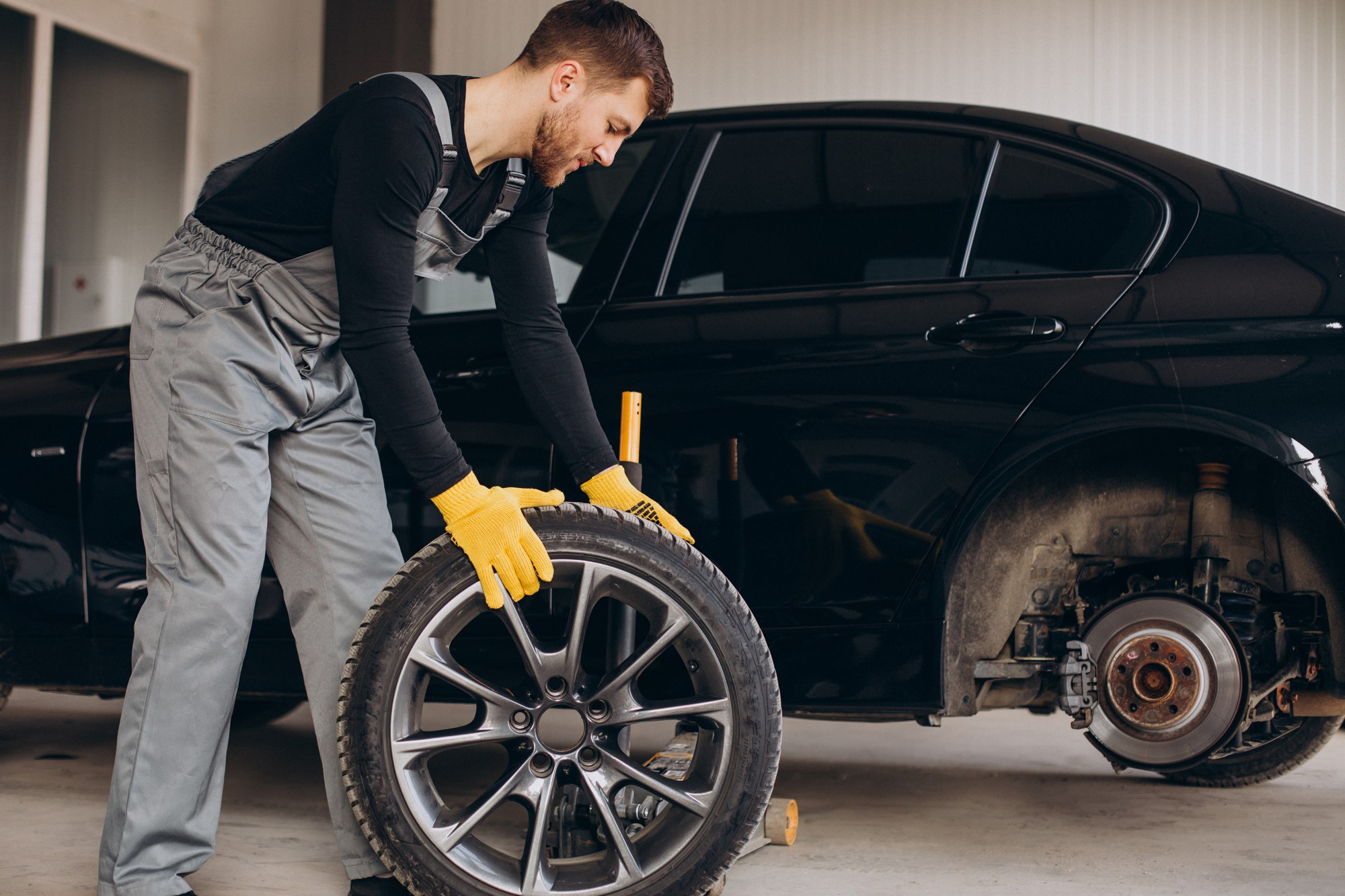 Mechanic rolling away the tire for repair